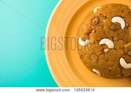 Moong Dal Halwa - a sweet dish from India, Indan Sweet Halwa made from Moong Dal, moong dal sweet sheera or shira cooked in pure ghee, served in a yellow ceramic plate