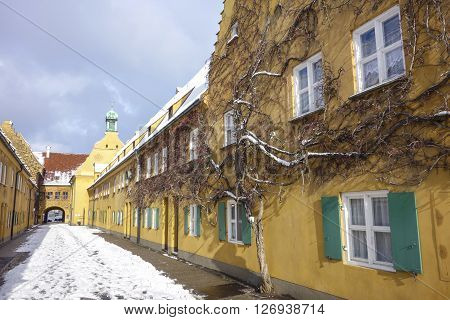 Augsburg Germany - January 17 2016: The Fuggerei is the world's oldest social housing complex still in use. It is a walled enclave within the city of Augsburg Bavaria.