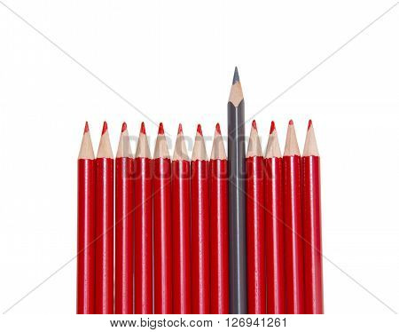 Black pencil standing out from the red pencils isolated