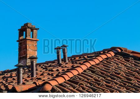Chimneys of different shapes on the roof
