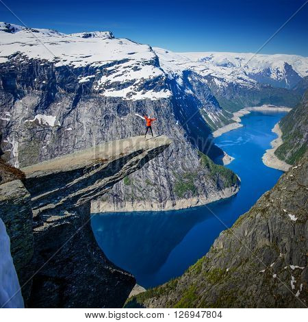 Amazing Famous Norway Trolltunga view point at morning with snow at the top of mountain