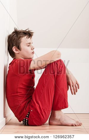 Withdrawn Tired Boy In Red Pants And Shirt
