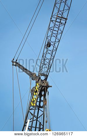 Mobile construction tower crane against blue sky