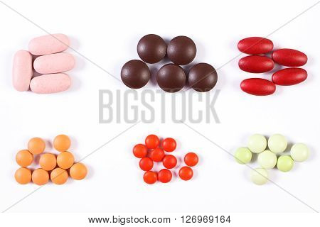 Colorful medical pills tablets capsules or supplements for therapy on white background concept of treatment and health care