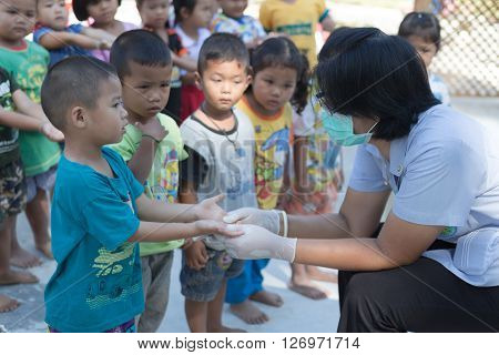 Yasothorn THAILAND DEC-01 : Health worker finding new case of Hand foot mouth disease in child on December 01,2015 at village in Yasothorn Thailand