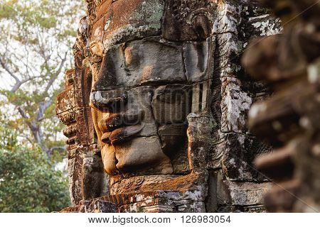 Towers with faces in Angkor Wat a temple complex in Cambodia and the largest religious monument in the world. UNESCO World Heritage Site.
** Note: Shallow depth of field