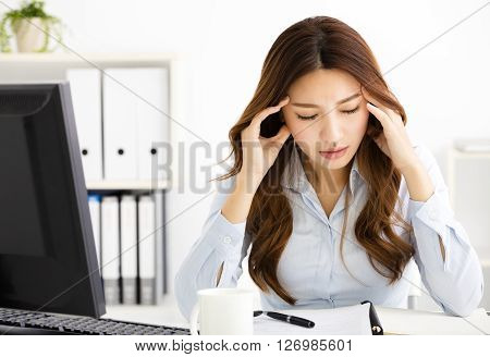 Portrait of tired young business woman working in office