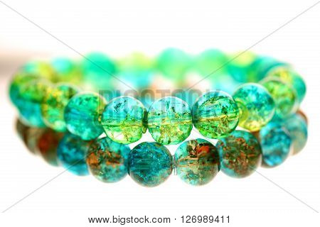 Glass colour bracelet on white isolated background