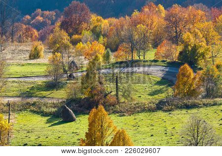 Dirty Secondary Road To Mountain Pass In Autumn Carpathian Mountains And Multicolored Yellow-orange-