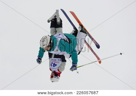 KRASNOE OZERO, LENINGRAD REGION, RUSSIA - FEBRUARY 1, 2018: Michail Dolmatov (7) and Nikita Novitckii, both of Russia, compete in dual mogul during Freestyle Europa Cup competitions