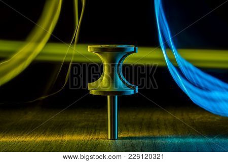 Milling Cutter On The Table. Blue And Yellow Blurred Stripes. Light Effect. Router Machine Bits.