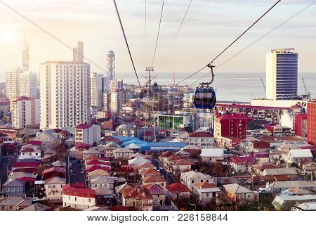 Aerial Cableway Above City Roofs Of Batumi, Georgia. Urban Landscape With High-rise And Ordinary Sin