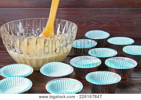 Molds For Muffins On A Wooden Table