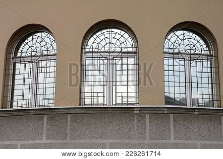 Three Arch Windows With Security Bars Building