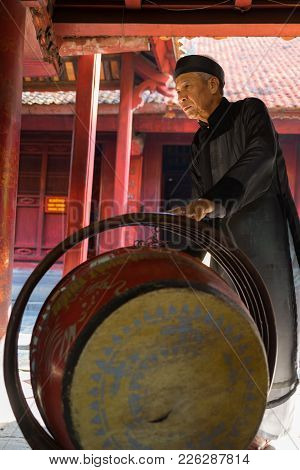Hanoi, Vietnam - July 24, 2016: Old Man Beating Drum Made Of Wood And Water Buffalo Leather At Templ