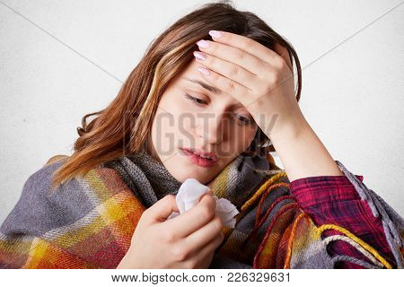 Allergic Woman Has Headache Because Of Blocked Nose, Keeps Hand On Forehead, Has High Temperature, F