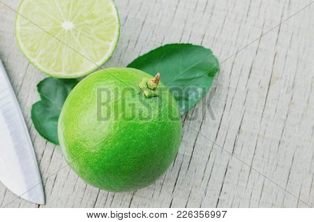 Freshl Emon Cut On Wooden And Knife.