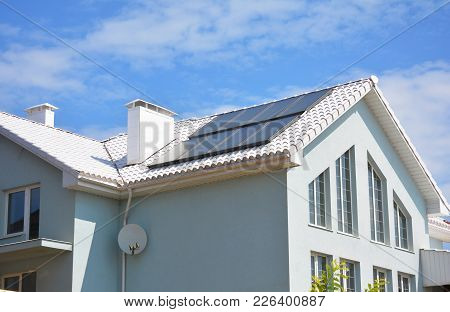 White Clay Tiled Roof And Solar Panels, Solar Water Heating For House Energy Efficiency. Modern Hous