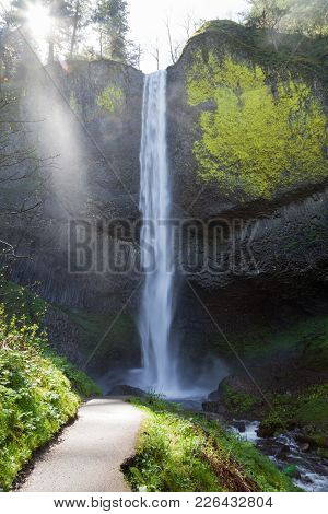 A Paved Pathway Leading To A Spectacular View Of Latourell Falls Cascading Over A Rock Cliff With Br