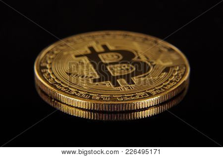 Golden Coin As A Symbol Of Bitcoin Crypto Currency Isolated On The Black Background