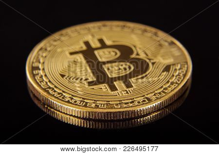 Golden Coin As A Symbol Of Bitcoin Crypto Currency Isolated On The Black Background
