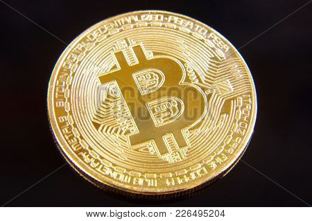 Golden Coin As A Symbol Of Bitcoin Crypto Currency Isolated On The Black Background