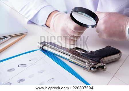 Criminologist police chemist looking at crime evidence
