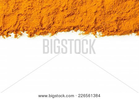 Curcuma Ground Powder Isolated On White Background. A Band Or Streak Of Curcuma Is Located On The To