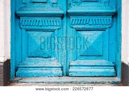Close-up The Element Of Blue Many Times Painted Cracked Double-barreled Wooden Vintage Door Of The L