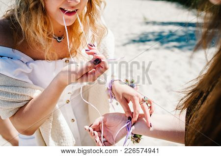Beautiful Sexy Girls оn Sand Beach Background Nature. Bride's Girlfriend Biting Her Teeth Ribbon For