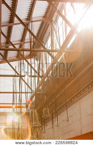 Light Streaming Through Window In Old Factory With Lens Flares.