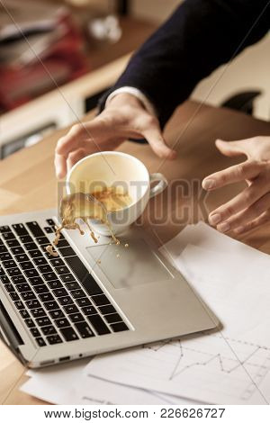 The Male Hands And Coffee In White Cup Spilling In Slow Motion Or Movement On The Table With Laptop 