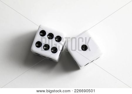 Dice Shot Up Against A White Background, Seven