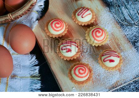 High angle view of egg tarts on the wooden board.