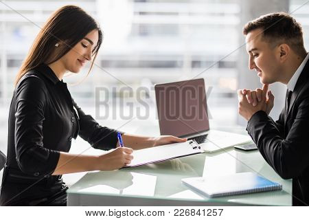 Business Partners Signing Contract At Office Desk