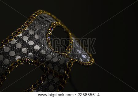 Mardi Gras Mask With Gold Against A Dark Almost Grey Background