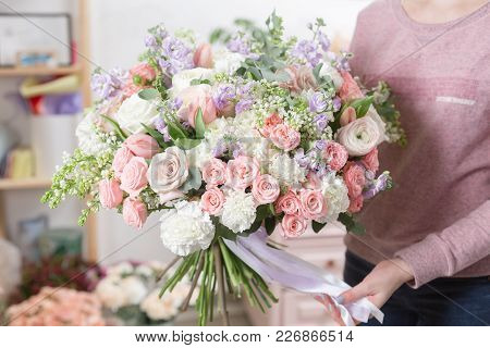 Beautiful Luxury Bouquet Of Mixed Flowers In Woman Hand. The Work Of The Florist At A Flower Shop. C