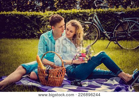 Lovely Couple On Picnik In A Park In Summer Sunny Day.