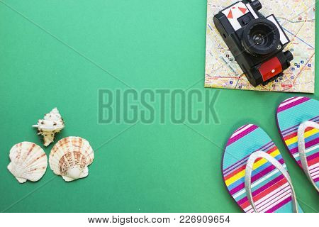 Travel Or Tourism Concept - Beach Sleepers, A Rall Film Camera On A Folded Map On One-color Backgrou