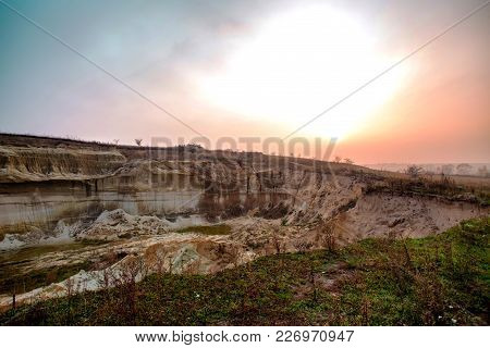 Sand Mining Quarry In Ukraine. Deep Plumage. Sunset In The Fog Over The Quarry