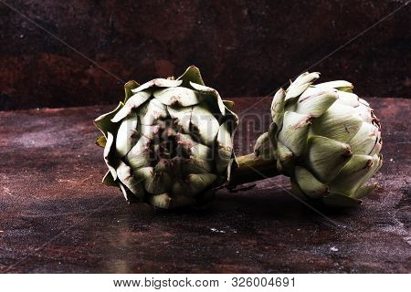 Artichokes On Rustic Dark Background. Fresh Organic Artichoke Flower.