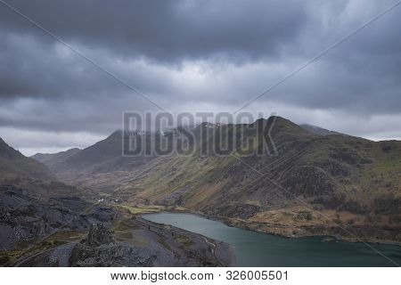 Stunning Landscape Image Of Dinorwig Slate Mine And Snowcapped Snowdon Mountain In Background During