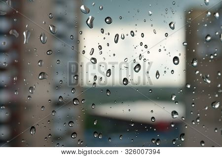 Rainy Weather And Raindrops On A Window Glass.