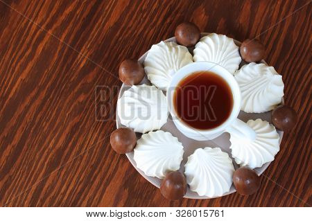 Dish With Marshmallows And Sweets On A Wooden Background