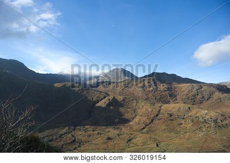 Wales, On A Winters Day Mount Snowden Is In All It's Beauty. Clear Blue Sky With Only Scattered Clou