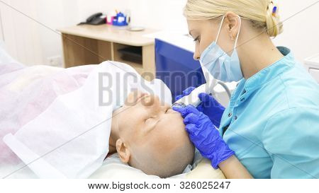 Microneedle Rf Lifting Procedure. Hardware Cosmetology. Beautician Conducts A Facial Rejuvenation Pr