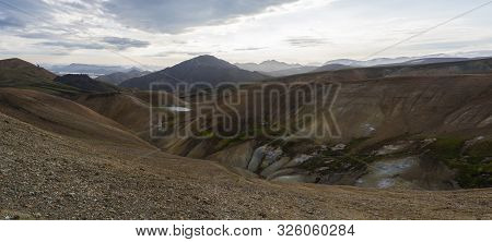 Colorful Rhyolit Mountain Panorma With Multicolored Volcanos And Geothermal Fumarole, Lake And River