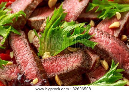 Beef Steak With Romesco Sauce, Nuts And Vegetables On White Plate