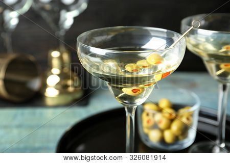 Glass Of Classic Dry Martini With Olives On Wooden Table, Closeup