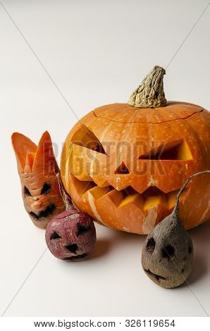 Jacks Head Of A Lantern Carved From Pumpkin For Halloween With Evil Vegetables